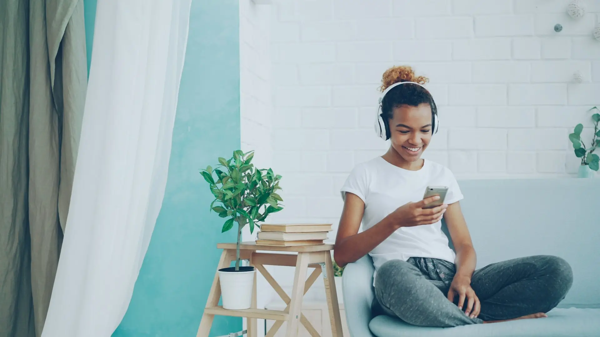 A young woman on her phone at home, checking in on someone.