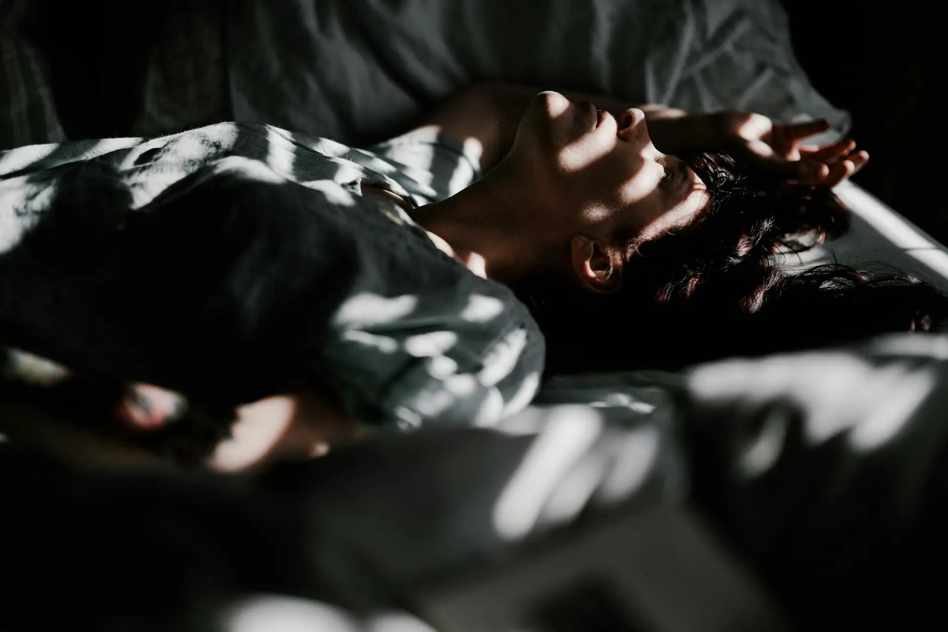 Someone asleep, head resting on a pillow.